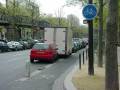 Narrow bike lane behind parked cars